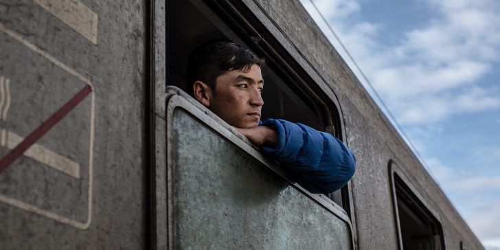 An Afghan refugee looks out of train windows at the train station in Sid, Serbia. Refugees and migrants transiting through the Balkans on their way North in Europe are put on trains from here to bordering Croatia. ; In early November 2015, Serbia and bordering Croatia introduced a new system to shuttle refugees and migrants over their borders, which reduces waiting times out in the cold as winter approaches. Previously, refugees and migrants had to wait outside for hours and trek about two kilometers to get from Serbia to Croatia.